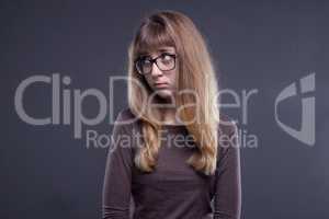 Offended young girl in glasses