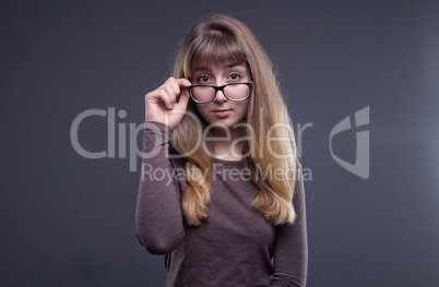 Welcoming teenage girl in glasses