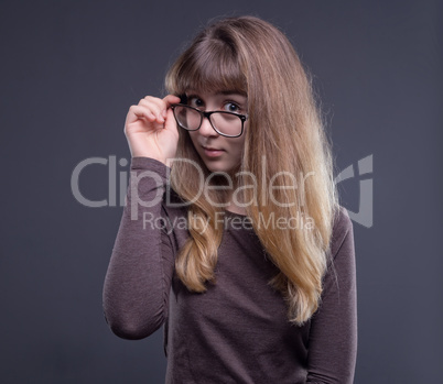 Teenage girl holding glasses