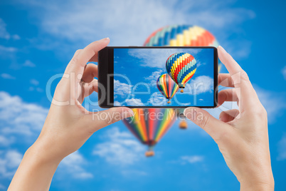 Female Hands Holding Smart Phone Displaying Photo of Blue Sky wi