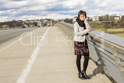 Woman standing on a road bridge