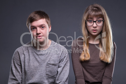 Portrait of surprised teenage couple