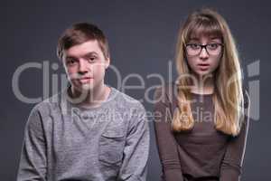 Portrait of surprised teenage couple
