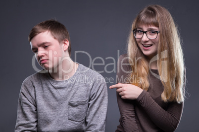Sneering young woman and man