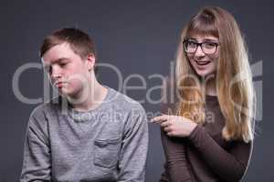 Sneering young woman and man