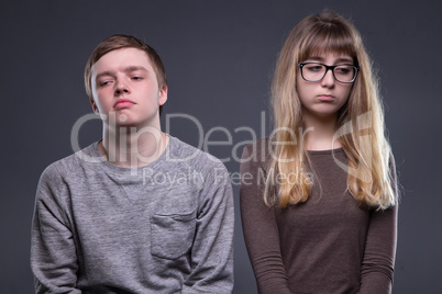 Offended young woman and man
