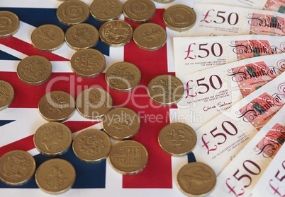 Pound coins and notes, United Kingdom over flag