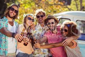 Group of friends toasting beer bottles