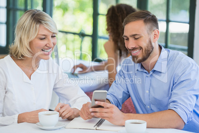 Executives using mobile phone in a restaurant