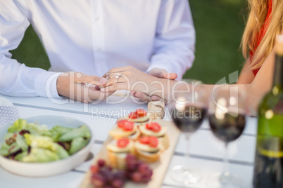 Man holding womans hand in the restaurant