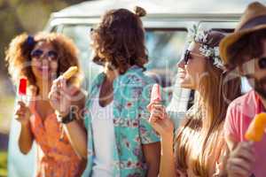 Group of friends enjoying and eating ice lolly