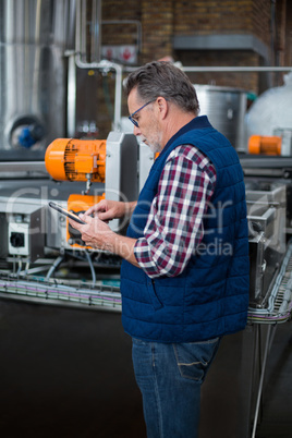 Factory worker working on digital tablet in the factory