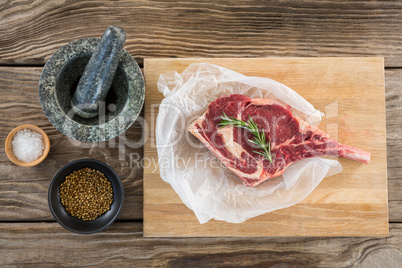 Rib chop, rosemary herb, salt, corainder seeds and stone grinder