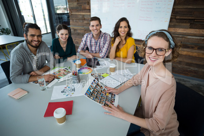 Smiling graphic designers sitting in office