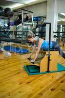 Determined woman exercising on wunda chair