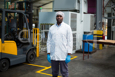 Factory engineer standing in bottle factory