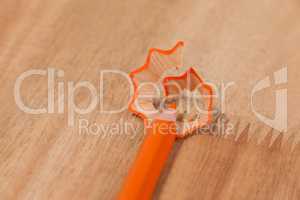 Close-up of orange colored pencil with shavings