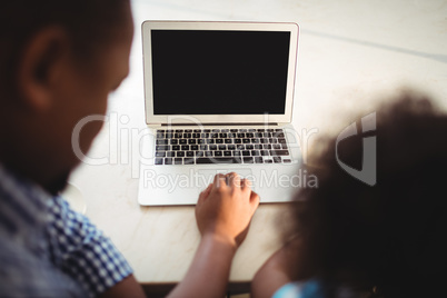 Father and daughter using laptop