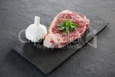 Sirloin chop and garlic on slate plate