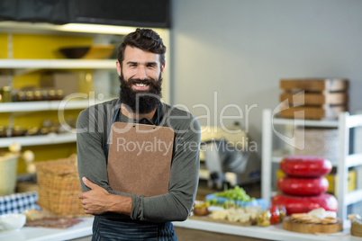 Portrait of salesman holding clipboard at counter