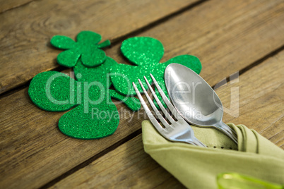 St Patricks Day fork and spoon wrapped in napkin with shamrocks