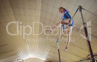 Female gymnast practicing gymnastics on the horizontal bar