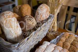 Close-up of fresh bread in a wicker basket on counter