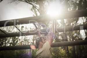 Soldier climbing monkey bars