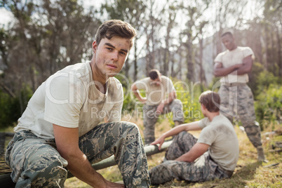 Soldier tying his shoe laces in boot camp