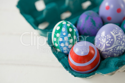 Multicolored Easter eggs in the carton