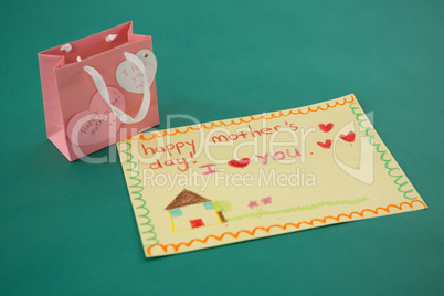 Pink gift bag with heart shape tag and greeting card