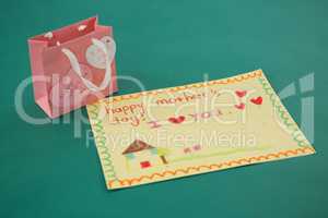 Pink gift bag with heart shape tag and greeting card