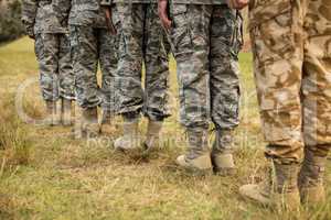 Low-section of military soldiers standing in line