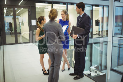 Businesspeople having a discussion in the corridor