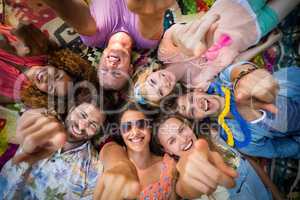 Group of friends lying in a circle at campsite