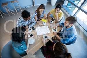 Creative business team having meeting over coffee in meeting room