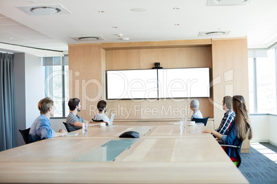 Creative business team attending a video call in conference room