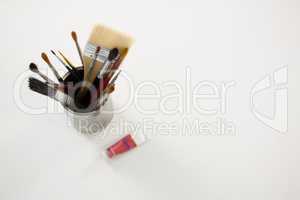 Paintbrushes and watercolor on white background