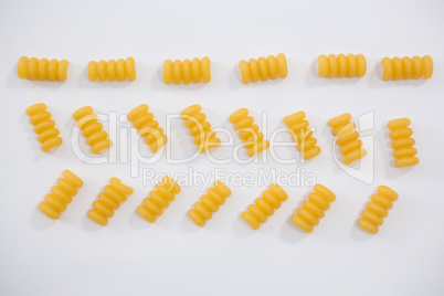 Riccioli pasta arranged on white background