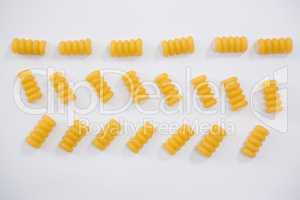 Riccioli pasta arranged on white background