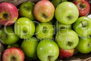 Red and green apples in wicker basket
