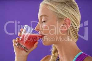 Beautiful woman drinking smoothie
