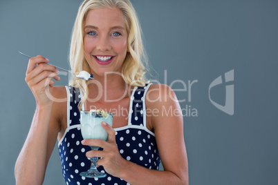 Portrait of beautiful woman eating ice-cream