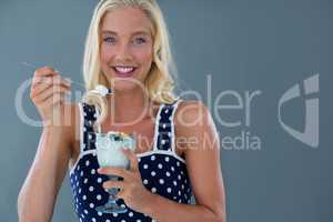 Portrait of beautiful woman eating ice-cream