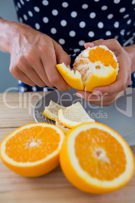 Woman peeling orange