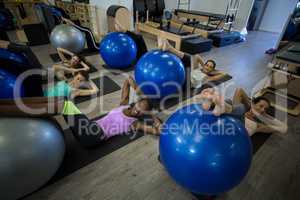 Smiling women exercising with fitness ball