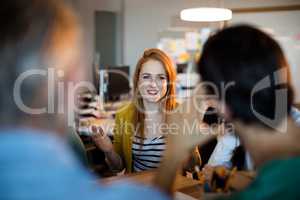 Smiling woman talking to her team