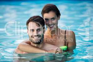Young couple embracing each other in the pool