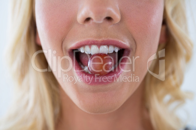 Beautiful woman eating red grapes