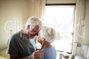 Senior couple romancing in bedroom